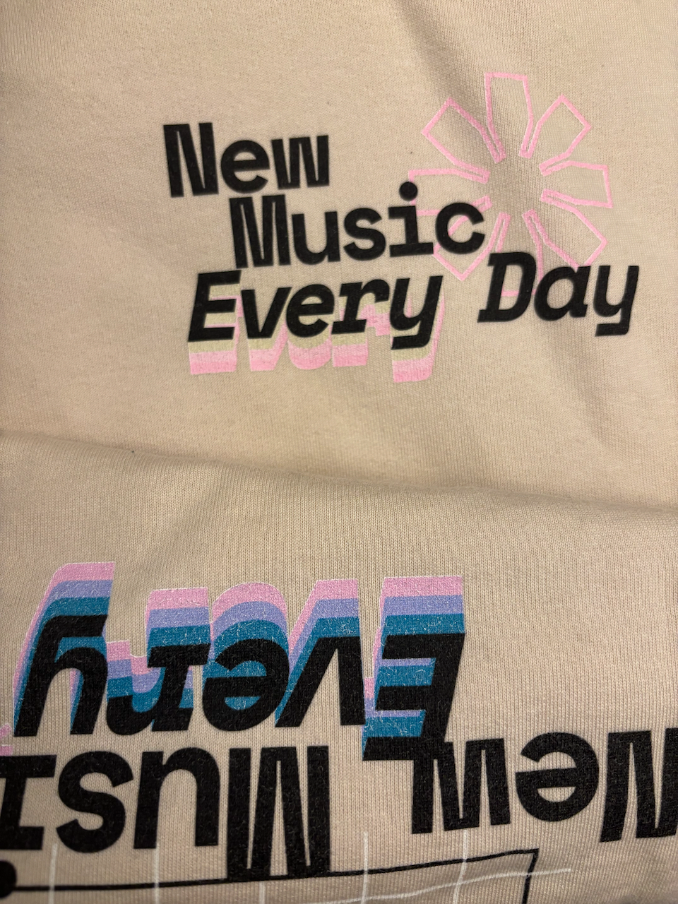 The misprint on the front of the jumper, compared to the back.